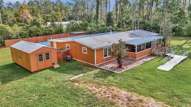 a aerial view of a house with backyard