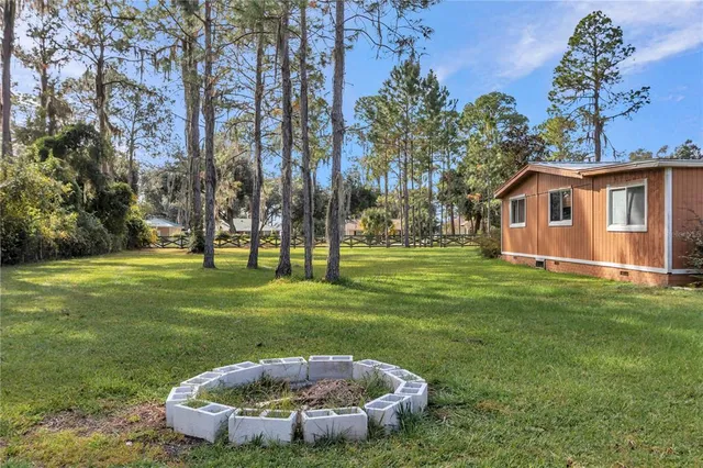 an aerial view of a house with balcony and trees
