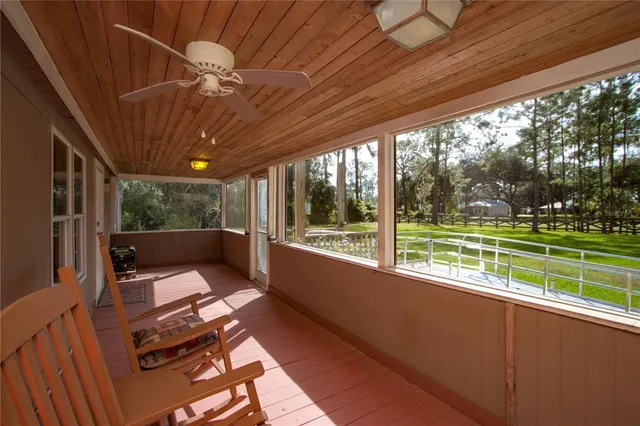 a balcony with furniture and a potted plant