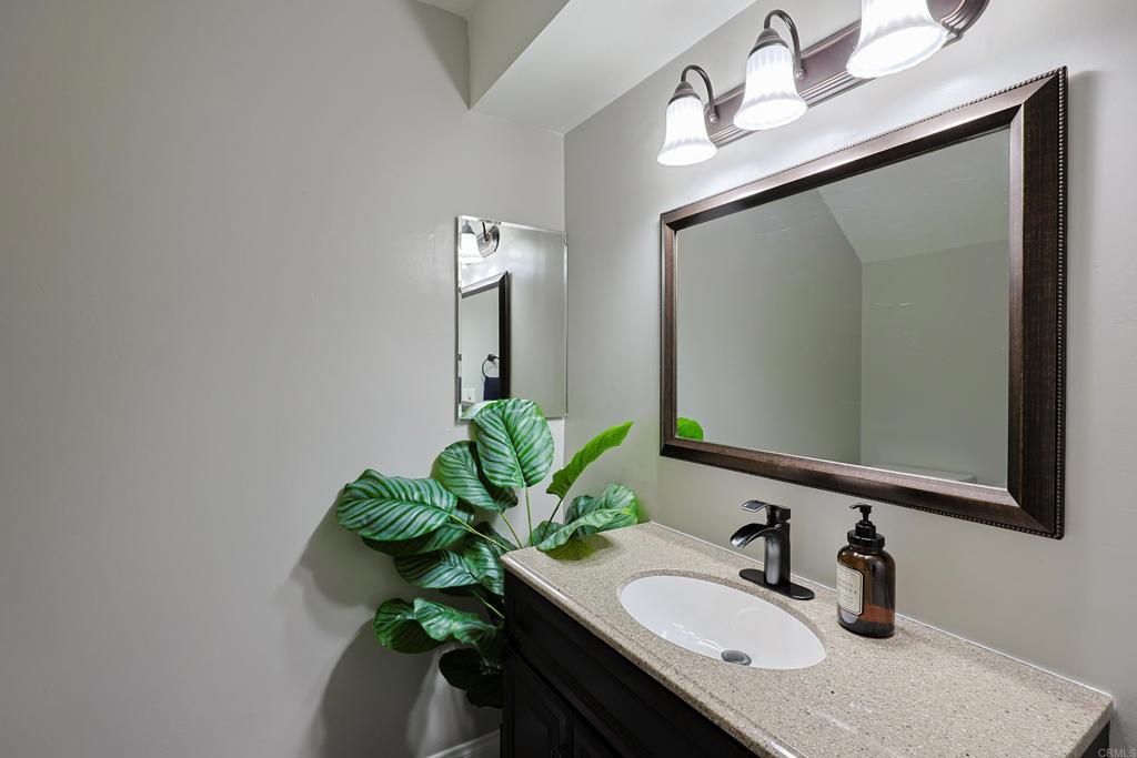 10225 Molino Road Santee, CA 92071 - Photo 12 of 53 a bathroom with a sink a vanity and a mirror