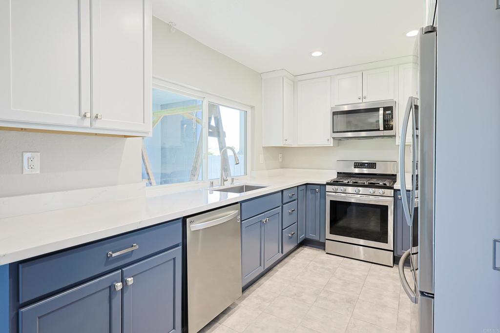 10225 Molino Road Santee, CA 92071 - Photo 13 of 53 a kitchen with stainless steel appliances granite countertop a sink and a stove