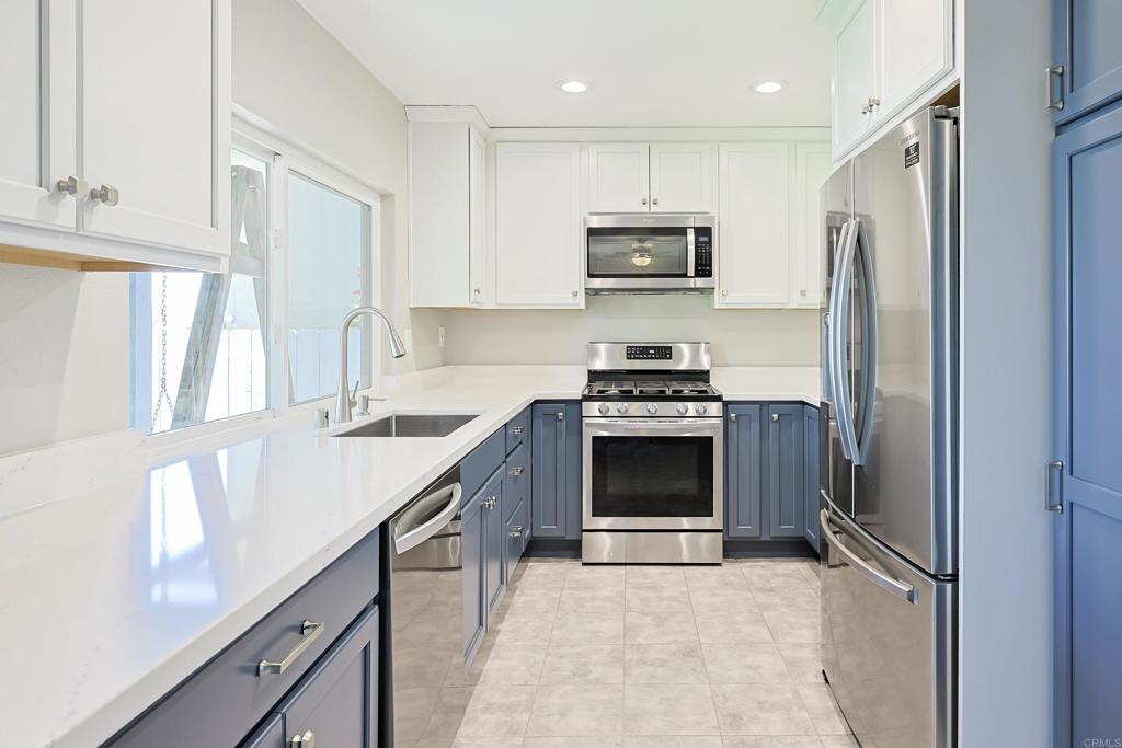 10225 Molino Road Santee, CA 92071 - Photo 14 of 53 a kitchen with stainless steel appliances a stove a sink and a refrigerator