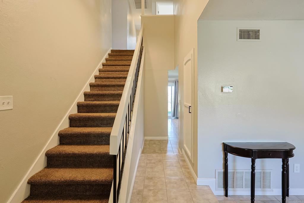 10225 Molino Road Santee, CA 92071 - Photo 20 of 53 a view of staircase with wooden floor and white walls