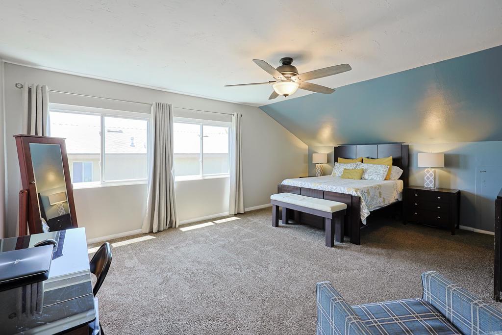 10225 Molino Road Santee, CA 92071 - Photo 21 of 53 a spacious bedroom with a bed and a chandelier