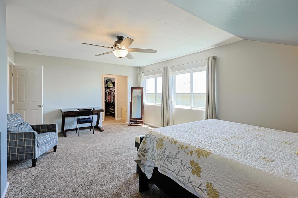 10225 Molino Road Santee, CA 92071 - Photo 22 of 53 a bedroom with a bed and a chandelier