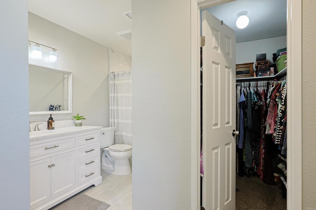 10225 Molino Road Santee, CA 92071 - Photo 24 of 53 a bathroom with a double vanity sink toilet and shower