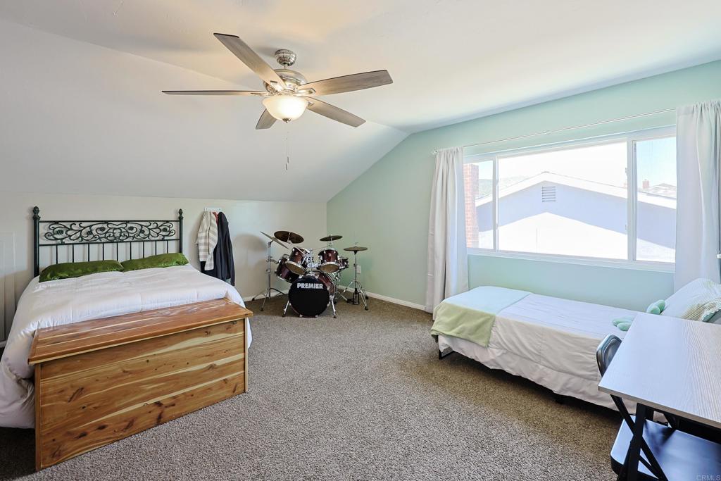10225 Molino Road Santee, CA 92071 - Photo 26 of 53 a bedroom with a bed and a chandelier