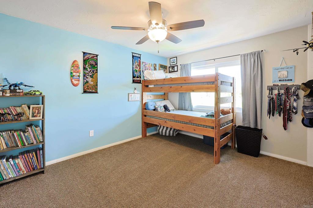 10225 Molino Road Santee, CA 92071 - Photo 28 of 53 a bedroom with furniture and a book shelf