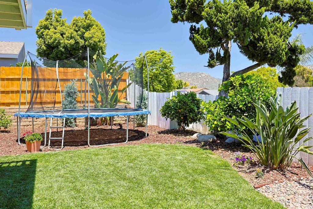 10225 Molino Road Santee, CA 92071 - Photo 42 of 53 a view of a garden with a bench in the garden