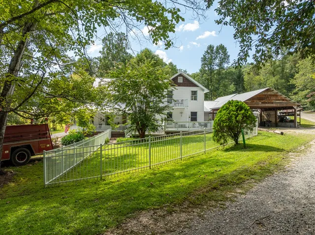 a kitchen with a sink dishwasher a stove and white cabinets