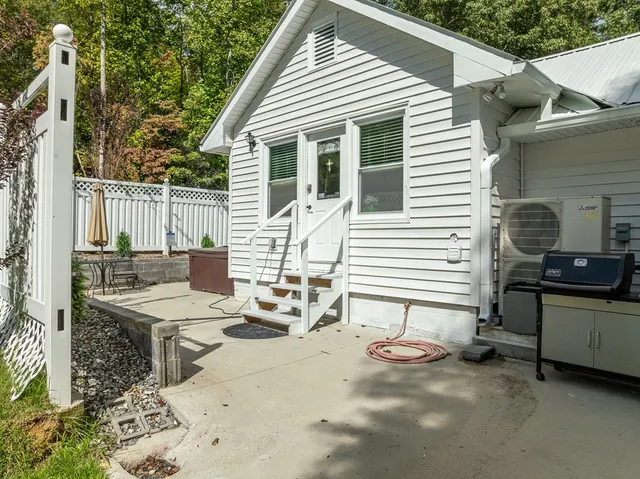 a bedroom with a bed a couch and a flat screen tv