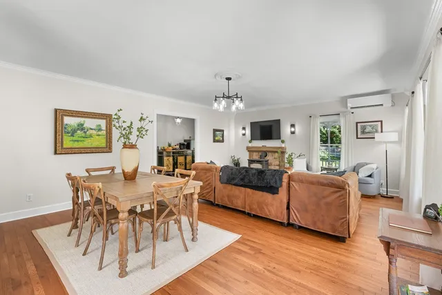 a bathroom with a sink a mirror a toilet and a window