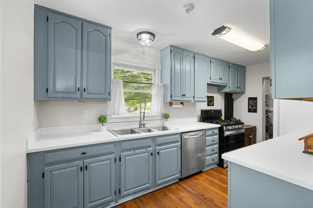 a view of a livingroom with wooden floor and a staircase