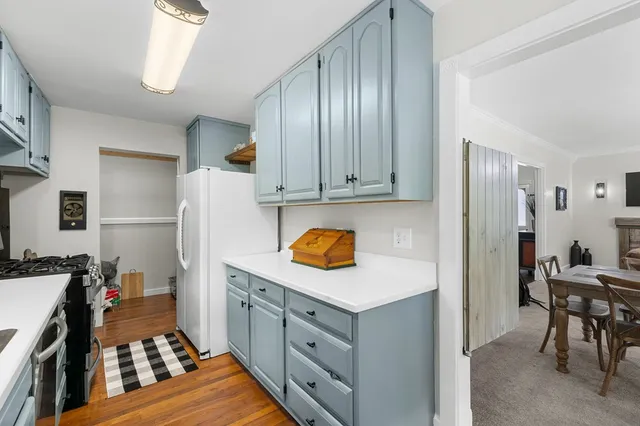 a spacious bedroom with a bed and a chandelier