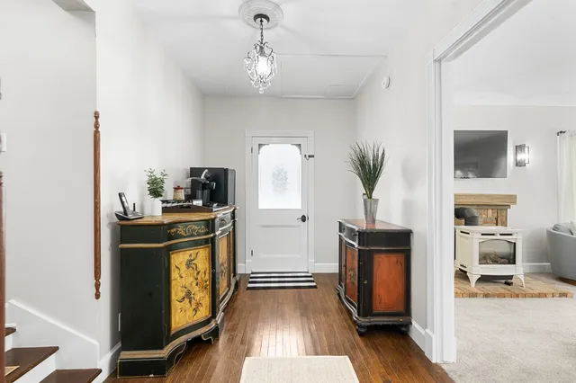 a spacious bedroom with a bed and a chandelier