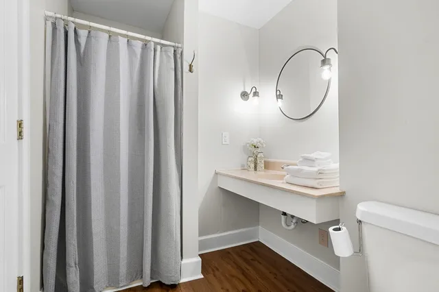 a spacious bedroom with a bed a couch and a window