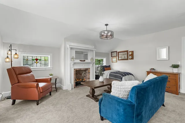 a living room with furniture fireplace and flat screen tv