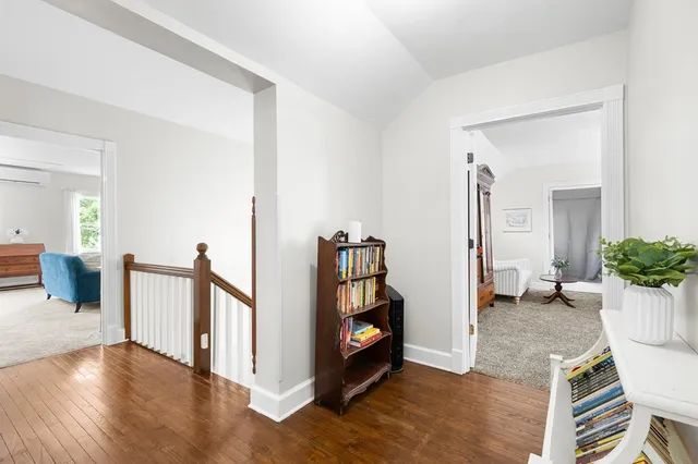 a bedroom with a bed lamp and a window