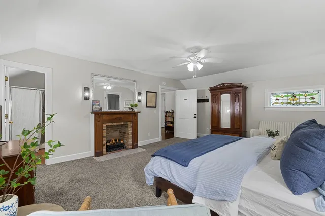 a spacious bedroom with a bed and a flat screen tv