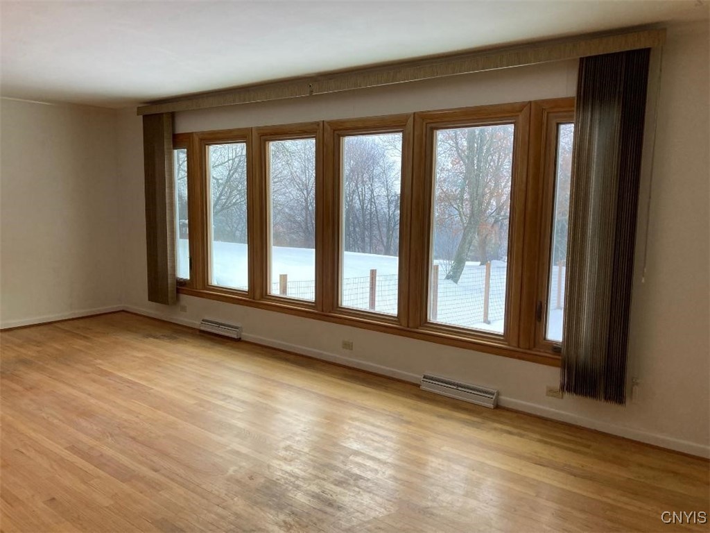 5758 Hamilton Road Elbridge, NY 13080 - Photo 18 of 27 The living room is huge. These windows overlook t