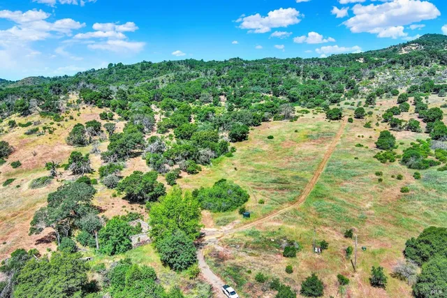 a view of a big yard with lots of green space