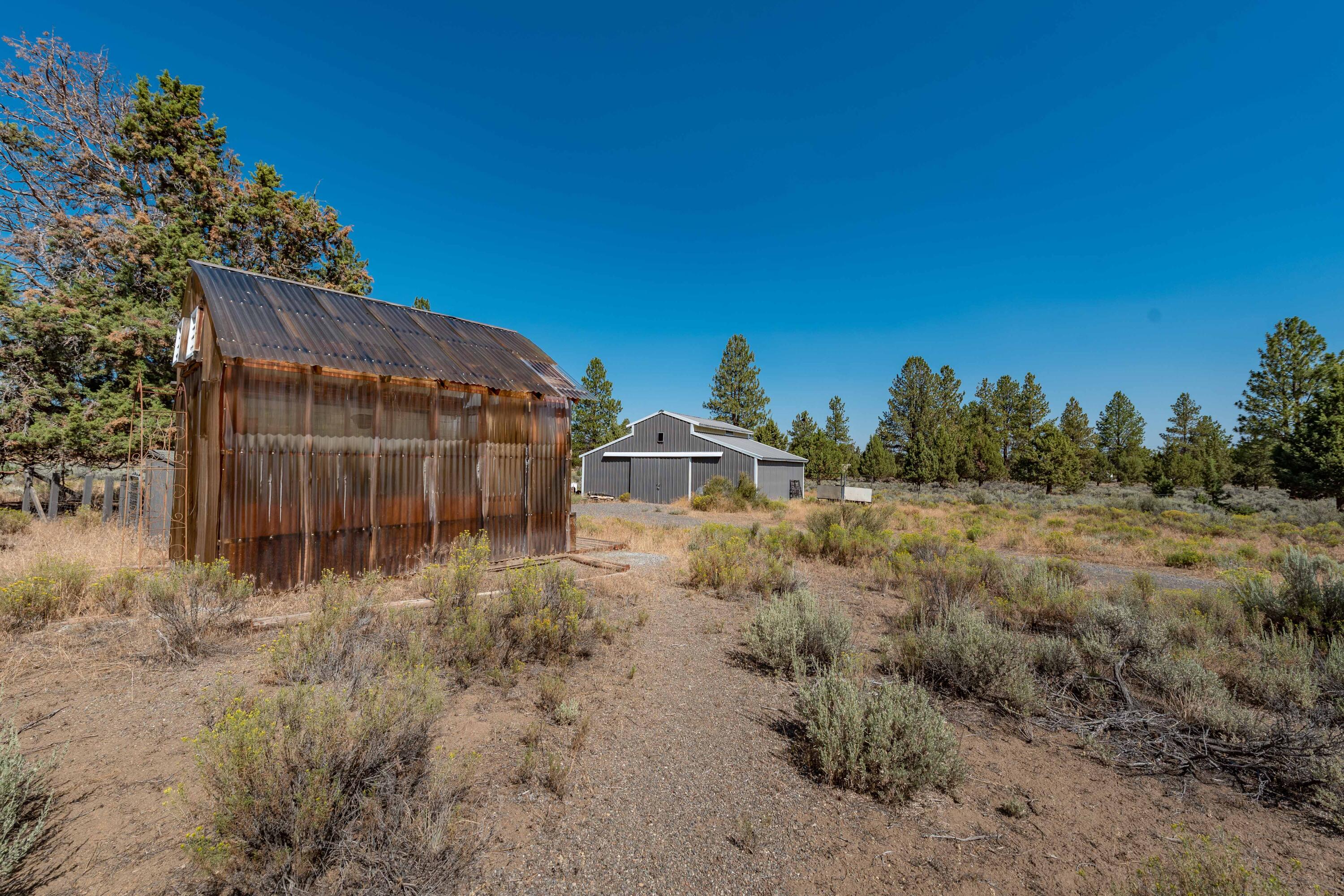 21698 Rickard Road Bend, OR 97702 - Photo 37 of 51 Greenhouse with barn in background.