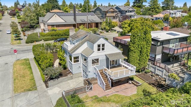 an aerial view of a house with swimming pool and sitting area