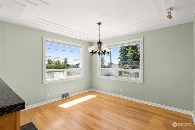 a view of an empty room with a window and fireplace
