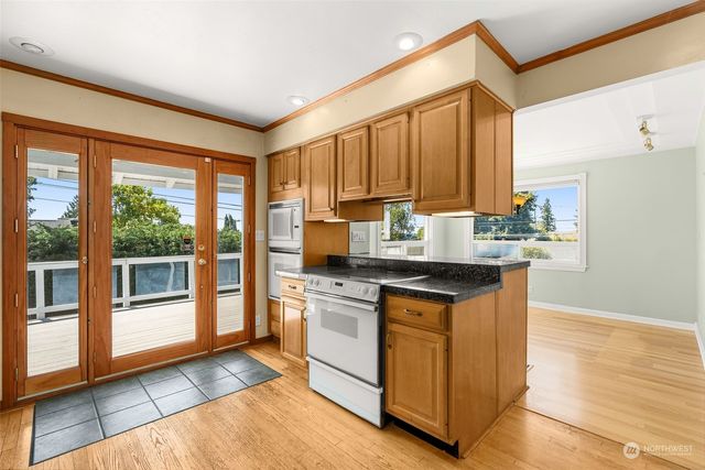 a kitchen with stainless steel appliances kitchen island granite countertop a refrigerator and microwave