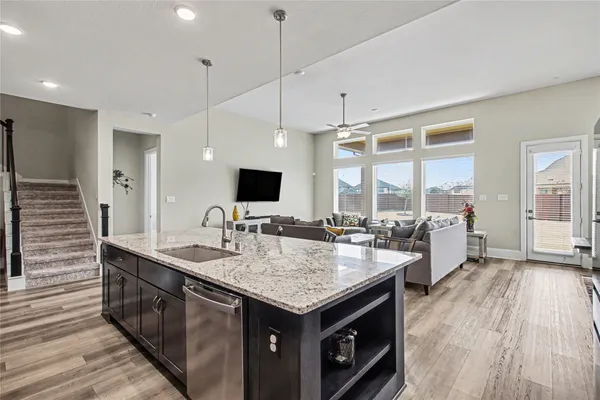 a kitchen with a stove center island and a wooden floor