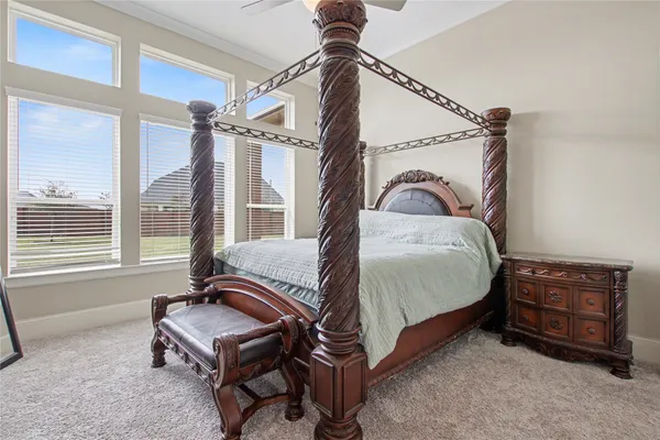 a bedroom with a bed a dresser and a window