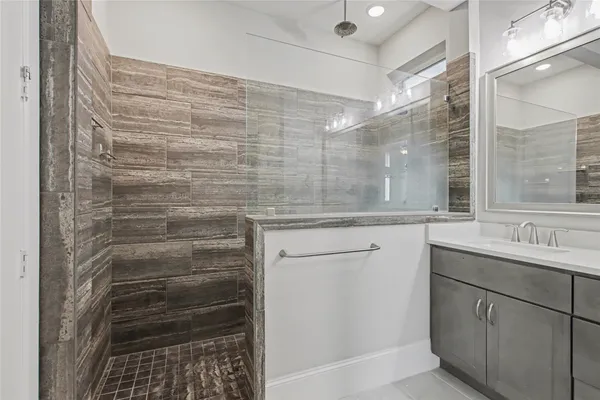 a bathroom with a shower and a sink