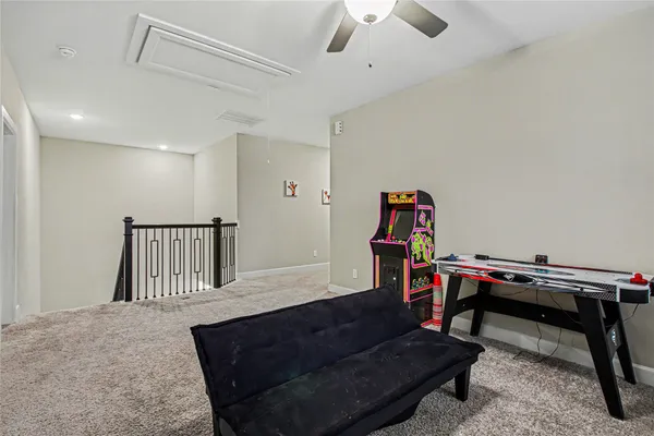 a living room with a piano furniture and a ceiling fan