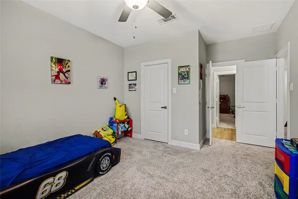 a bedroom with furniture and a wooden floor