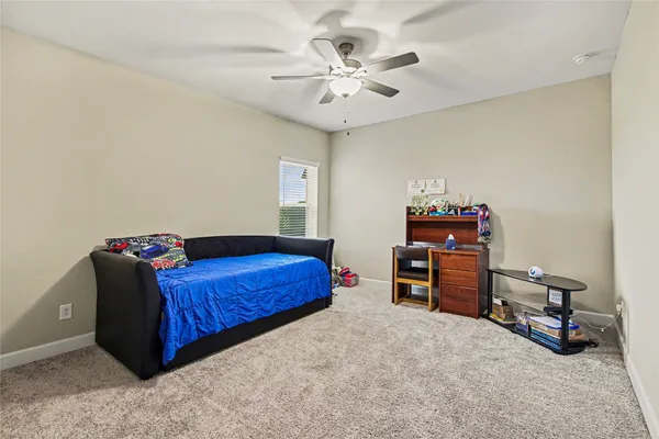 a bed room with a bed and a chair