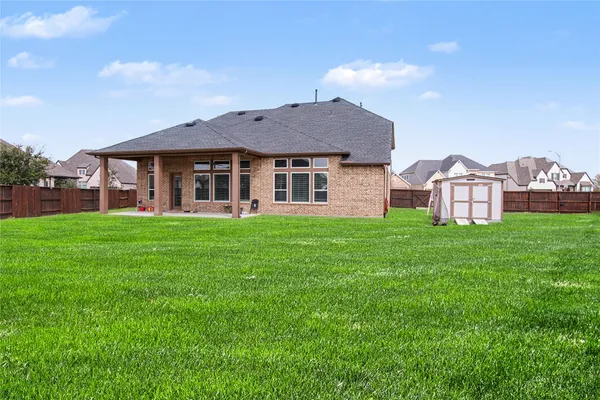 a view of a house with backyard porch and garden