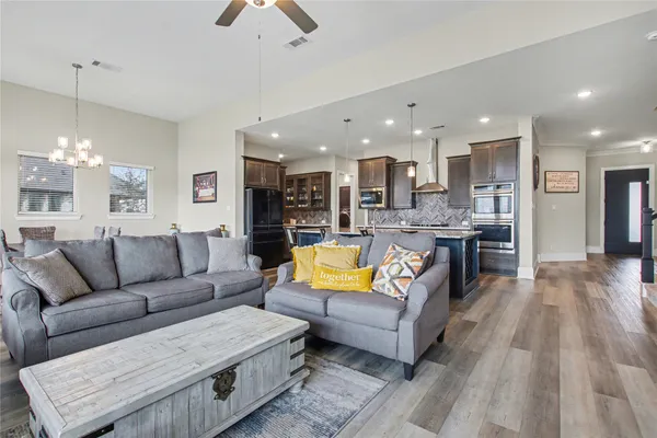 a living room with furniture and kitchen view