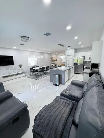 a kitchen with stainless steel appliances kitchen island granite countertop a sink and cabinets