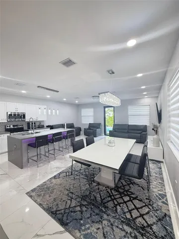 an open kitchen with a table and chairs
