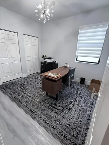 a bedroom with a bed and a large mirror on the roof