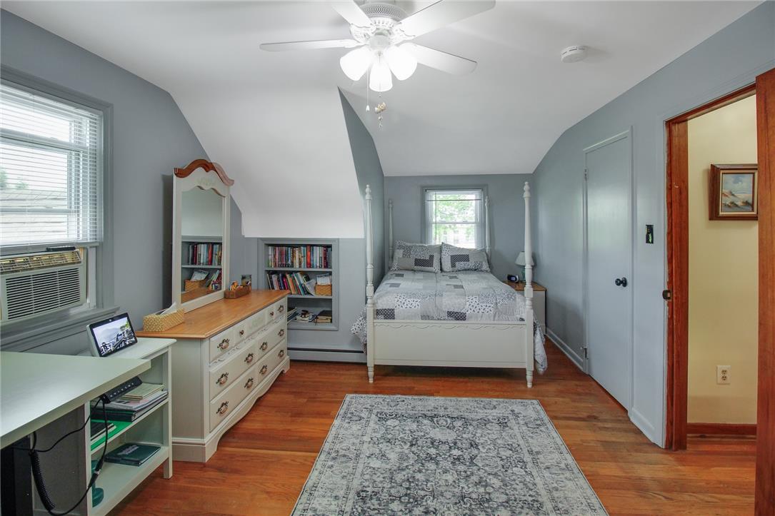 1256 Ridge Avenue Whitehall, PA 18052 - Photo 33 of 43 Hardwood floors and built-in shelving enhance the inviting ambiance of this well-lit bedroom.