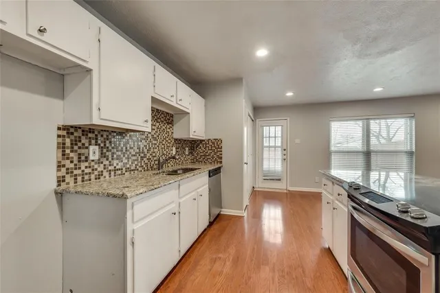 a kitchen with stainless steel appliances granite countertop a stove and a sink