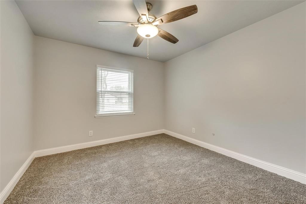 5220 Arbor Glen Road The Colony, TX 75056 - Photo 18 of 29 an empty room with a window and a fan