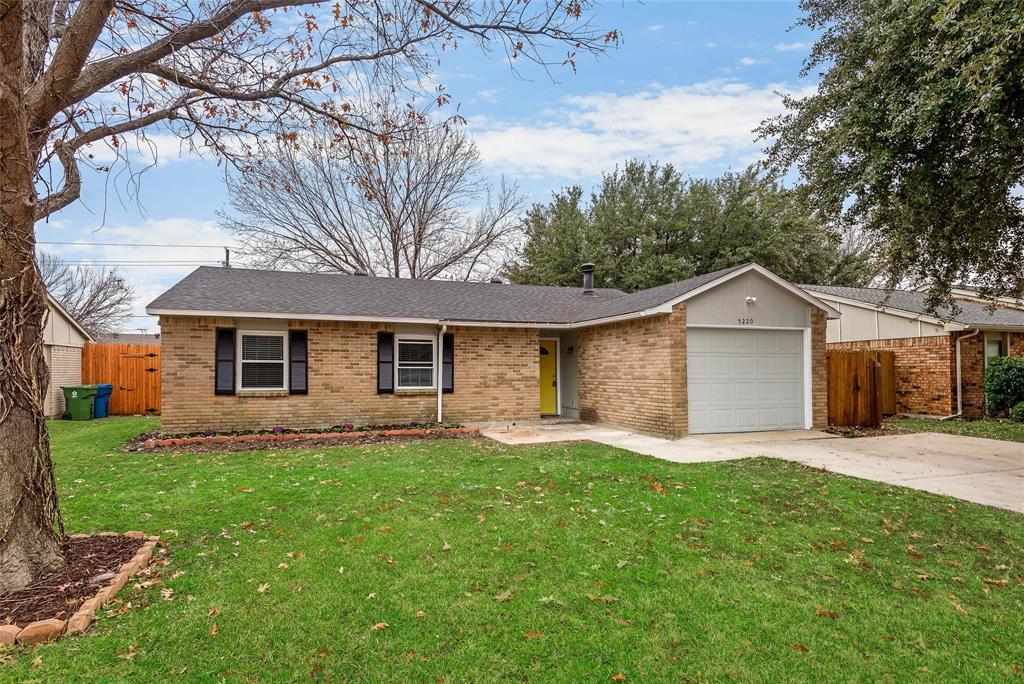 5220 Arbor Glen Road The Colony, TX 75056 - Photo 4 of 29 a front view of a house with a yard and trees