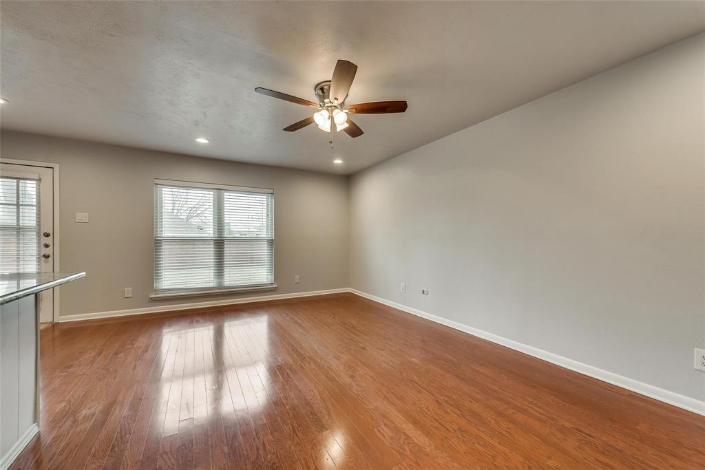 5220 Arbor Glen Road The Colony, TX 75056 - Photo 6 of 29 an empty room with wooden floor fan and windows