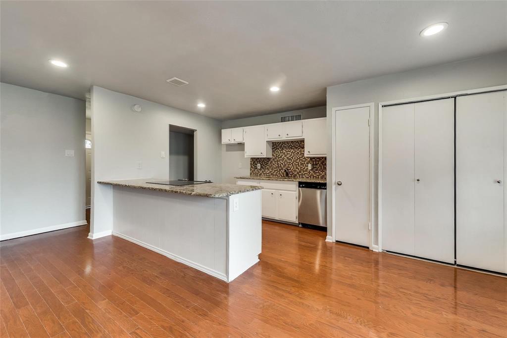 5220 Arbor Glen Road The Colony, TX 75056 - Photo 10 of 29 a kitchen with a refrigerator and white cabinets