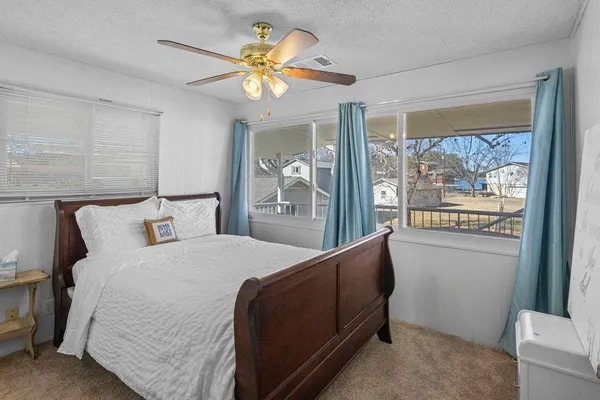a bedroom with a large bed and a chandelier