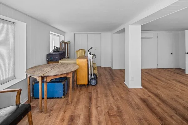 a room with kitchen island a wooden floor and a sink