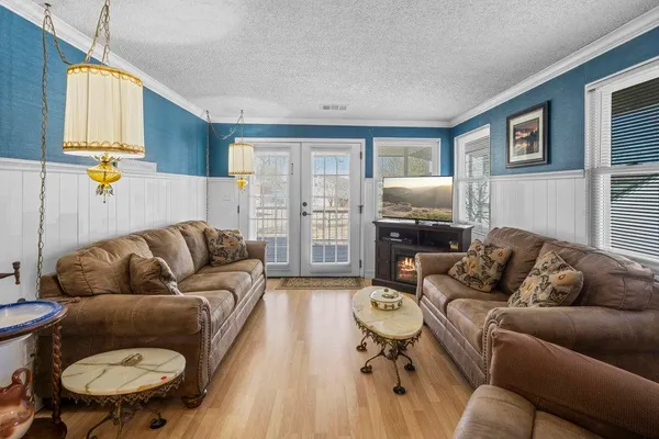 a living room with furniture and a lamp