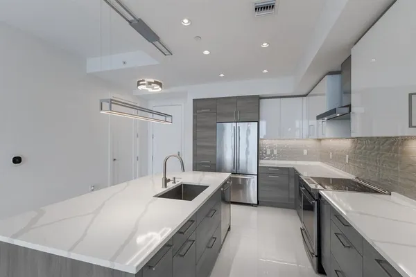 a kitchen with a sink a stove and cabinets